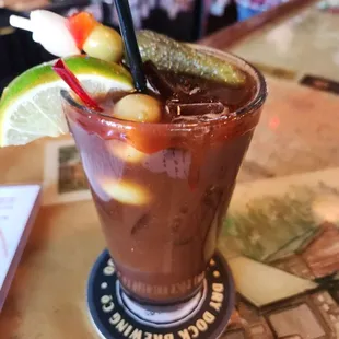 a bloody drink with pickles and cucumbers