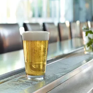 a glass of beer on the bar