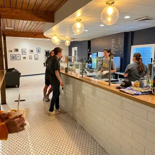 a group of people standing at the counter