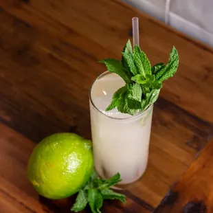 a glass of lemonade and a lime