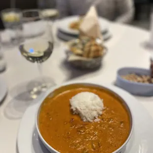 a bowl of soup and a glass of wine