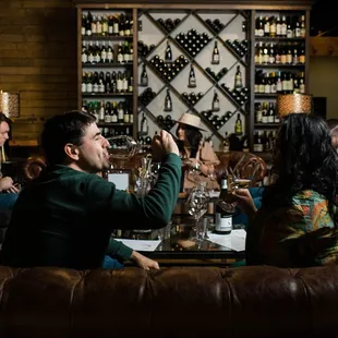 Gather with friends on our comfy couch seating located amongst walls filled from floor to ceiling wine.