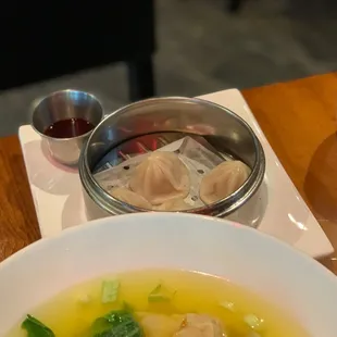 a bowl of soup with dumplings