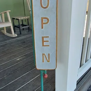 an open sign on the porch