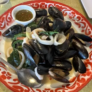 THAI HERBS STEAMED SEAFOOD mussels, shrimp, and squid steamed in Thai herbs, lemongrass, Thai basil, chili with Jeaw-Som dipping sauce