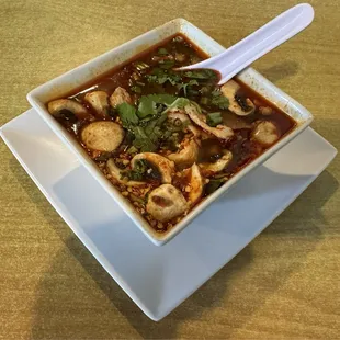 TOM YUM  spicy tangy herb soup, mushroom, galangal, lemongrass, shallot, lime leaves, cilantro, scallion, chili lime juice with chicken