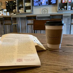 a cup of coffee and an open book