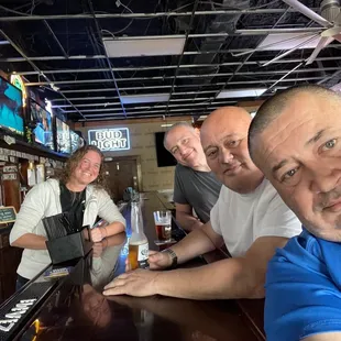 a group of people sitting at a bar