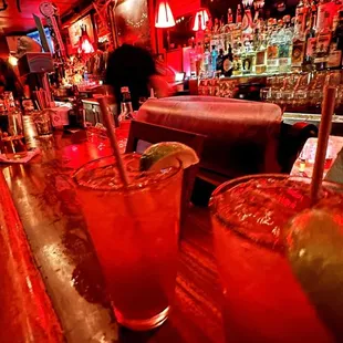 a bar with two cocktails on the bar