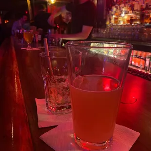a glass of orange juice on a bar