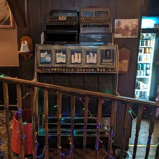 a room with a piano and a vending machine