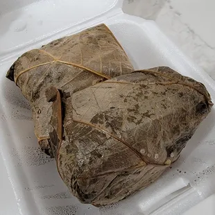 a piece of rice wrapped in a leaf