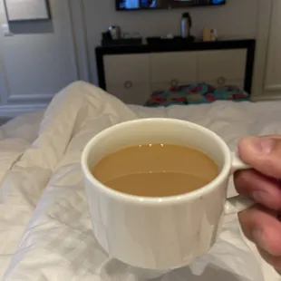 a person holding a cup of coffee