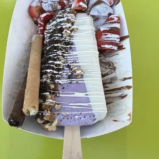 My customized paleta - taro half dipped in milk &amp; white chocolate, topped w/ pecans &amp; Oreos. a side of strawberries &amp; wafers