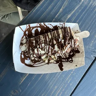 Coffee popsicle with dark chocolate drizzle and almonds