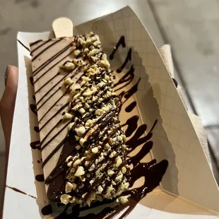 Hazelnut paleta half dipped in milk chocolate with mixed nuts