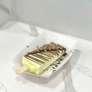 Avocado - half dipped with milk chocolate, drizzled chocolate, &amp; topped with mixed nuts