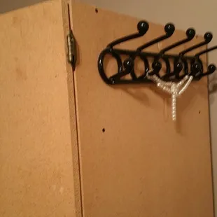 99-cent-store plastic hooks in case the single hanger inside this giant particle-board cupboard isn&apos;t adequate for your travel attire.
