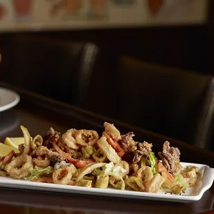 The Palm's Crispy Calamari Fritti, cornmeal-dusted with pickled lemon, peppers and marinara sauce