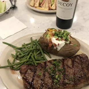 10 oz NY Strip Steak. Nicely prepared with green beans and loaded baked potato.