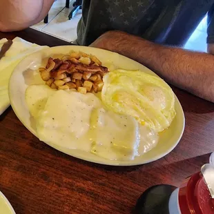 Biscuits and gravy, potatoes, eggs over easy