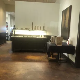 a dining area with a counter and chairs