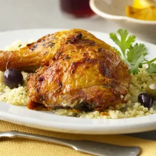 Organic roasted chicken quarter on a bed of hemp seed and black olives