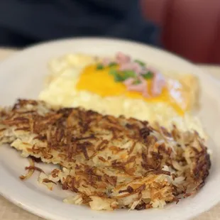 a plate of hash browns and eggs