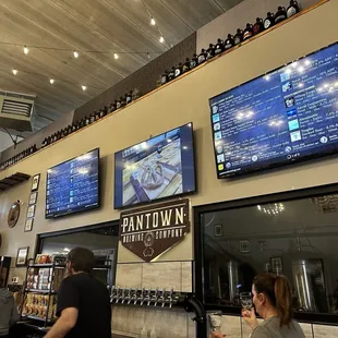 Front counter with a bunch of awesome growlers atop from around the nation! Brought in by various folks!