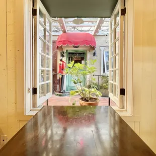 Indoor seat with a cute window opening.