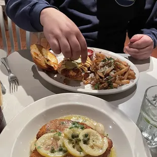 Chicken picatta and crispy chicken sandwich with truffle fries.