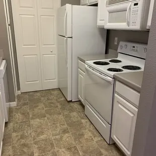 Kitchen 1BR unrennovated (in unit laundry behind closet doors)