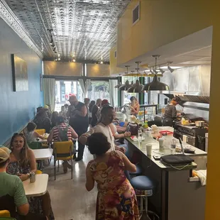 people sitting at tables in a restaurant