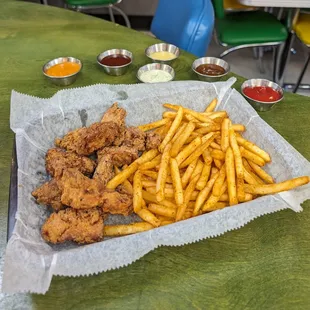Our Chicken Nuggies Basket comes with hand breaded chicken thigh nuggets, seasoned fries, and your choice of two house made dippin' sauces.