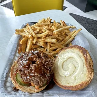 The crispy chicken sandwich comes with maple-gochujang sauce, kewpie mayo, kimchi, and the world's most delicious pickles.