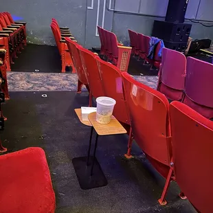 rows of red seats and a table