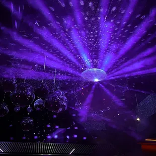 a disco scene with disco lights and disco balls