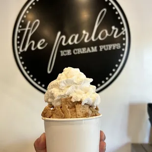 Single scoop of midnight in Paris with whipped cream and Cinnamon Toast Crunch