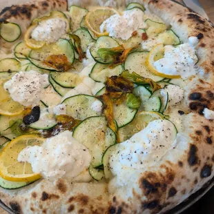 Pizza with zucchini, squash blossoms, lemon and ricotta cheese