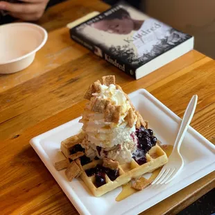 Waffle sundae with brown sugar oatmeal ice cream, blueberry compote, whipped cream, maple syrup, and Cinnamon Toast Crunch