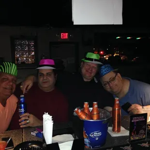 a group of men sitting at a bar