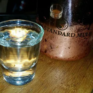 a glass of water and a copper mug