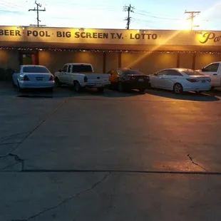 a group of cars parked in front of a big screen lot