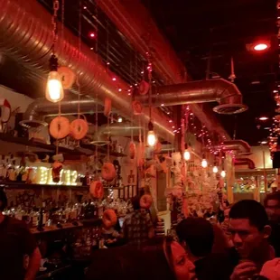 a crowded bar with red lights