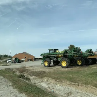 a tractor pulling a trailer full of plants