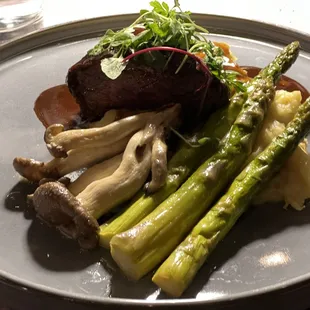 Filet mignon, med rare, wild mushrooms and asparagus with demi glaze. amazing!