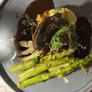 Filet mignon, med rare, wild mushrooms and asparagus with demi glaze. amazing!