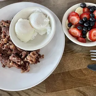 Corned beef hash, poached eggs and side of fruit.