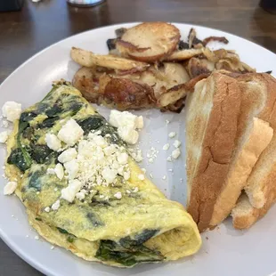 Spinach feta omelet with house potatoes and toast