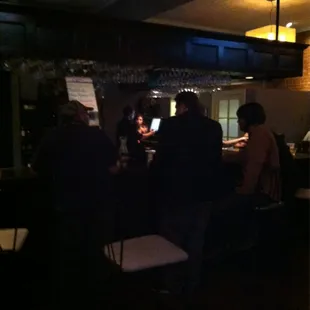 a group of people sitting at a bar